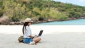 Lifestyle freelance woman using laptop working and relax on the beach.ÃÂ 